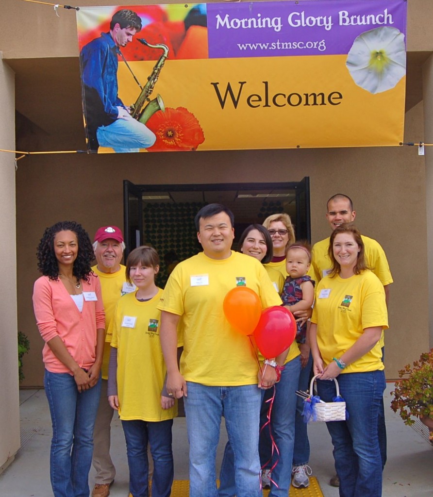 The morning shift of volunteers at Sophie's Center: (l-r) Jocelyne Campese '02, Bill McDonald '68, Julia McDonald x'12, Brian Tsu '00, Lissa Tsu '00 (holding Margot), Rebecca Reid '96, and Phil and Brianne Baxa '04. Some of these folks worked all day and others joined in the afternoon.