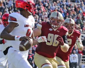 Carlsbad's own Ray Smith (96) takes aim at Louisville QB Lamar Jackson